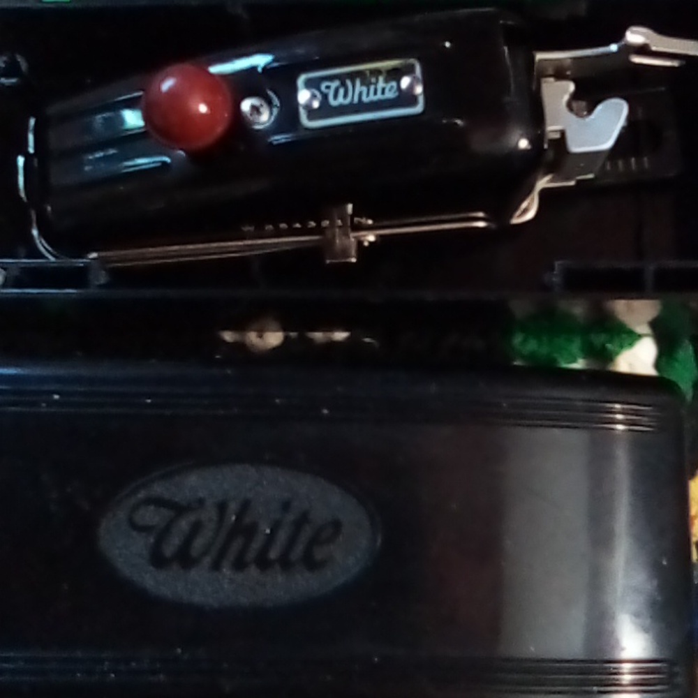 White vintage buttonholer in black case .